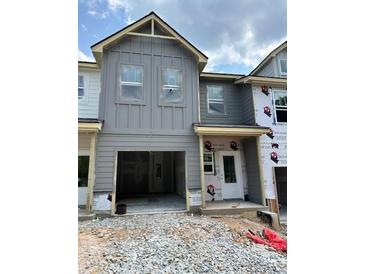 Under-construction gray two-story home featuring an attached garage and a classic architectural style at 27 Benscot Dr, Austell, GA 30106