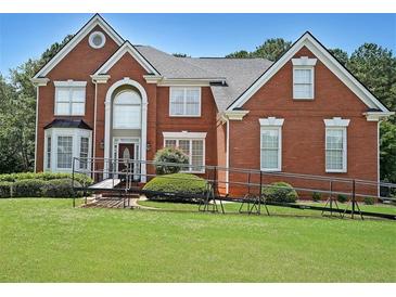Spacious two-story brick home with a well-manicured lawn and attractive landscaping at 2892 Motts Cove Holw, Lawrenceville, GA 30043