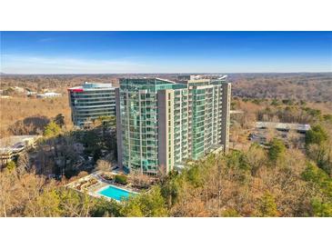 Luxury high-rise condominium building with rooftop pool and lush landscaping at 3300 Windy Ridge Se Pkwy # 1603, Atlanta, GA 30339