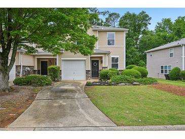 Inviting two-story townhome features charming curb appeal and an attached one car garage at 505 Rendezvous Rd, Acworth, GA 30102