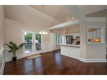 Bright dining area with hardwood floors, adjacent to kitchen and featuring French doors to outdoor deck at 102 Peaceful Vw, Acworth, GA 30102