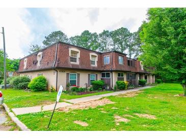 Charming multi-Gathering home with lush green lawn and manicured landscaping and inviting curb appeal at 2986 Parc Lorraine, Lithonia, GA 30038