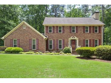 Beautiful two-story brick home featuring a well-manicured lawn and mature landscaping at 2101 Breconridge Sw Dr, Marietta, GA 30064