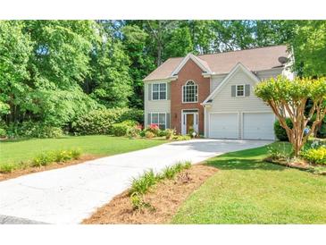 Charming two-story home with a well-manicured lawn, a two-car garage, and a long driveway at 190 Crestworth Ct, Powder Springs, GA 30127
