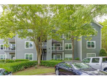 Exterior of the property featuring gray siding, balconies, and well-maintained landscaping and parking at 4106 Santa Fe Pkwy, Atlanta, GA 30350