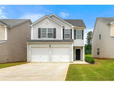 Charming two-story home featuring a two-car garage and well-maintained lawn at 7495 Garnet Dr, Jonesboro, GA 30236