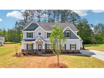 Charming two-story home featuring a gray color scheme and well-maintained landscaping at 3633 Squires Park Ln, Loganville, GA 30052