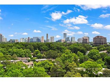 Stunning city skyline view from lush green neighborhood, framed by trees and a bright blue sky with fluffy white clouds at 3820 Roswell Ne Rd # 1001, Atlanta, GA 30342