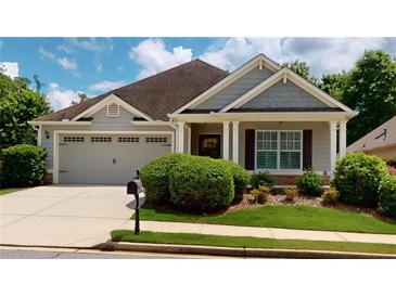 Charming single-story home featuring a well-maintained lawn, attached garage, and inviting front porch at 2058 Bonneville Ln, Powder Springs, GA 30127