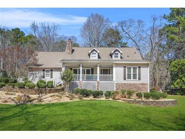 Charming single-Gathering home with stone accents, dormer windows and a beautifully landscaped front yard at 65 Deer Run Ln, Mcdonough, GA 30252
