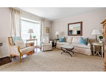 Cozy living room with neutral tones, plush seating, and bright natural light from large window at 136 Peachtree Memorial Nw Dr # Nh4, Atlanta, GA 30309