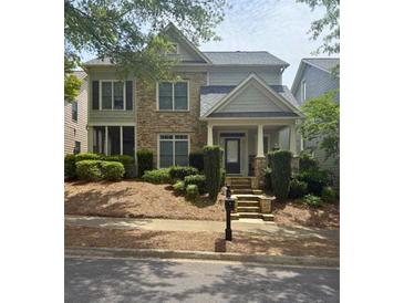 Charming two-story home featuring a stone facade, covered porch, and well-manicured landscaping at 4845 Backbay St, Suwanee, GA 30024