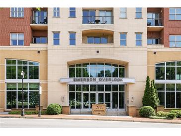 Emerson Overlook building entrance with glass doors, and manicured landscaping at street level at 326 Roswell Se St # 508, Marietta, GA 30060