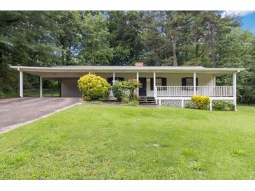Charming one-story home with a carport, covered porch, and a well-manicured front yard at 1353 Litchfield Ct, Snellville, GA 30078