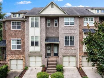 Attractive brick townhome with attached garages and well-maintained landscaping at 1973 Cobblestone Cir, Brookhaven, GA 30319