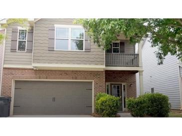 Charming two-story home with a brick facade and neutral siding accents at 678 Sweet Ashley Way, Loganville, GA 30052