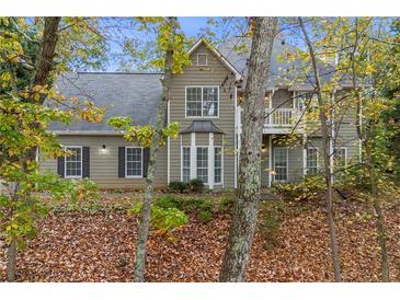 Charming two-story home featuring a well-maintained lawn and inviting front entrance at 7165 Jonsway, Cumming, GA 30041