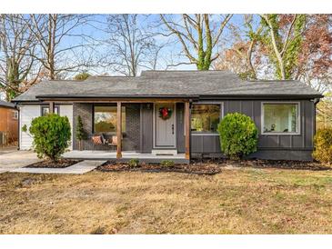 Charming single-story home featuring a cozy porch and stylish modern paint scheme at 1377 Dorothy Dr, Decatur, GA 30030