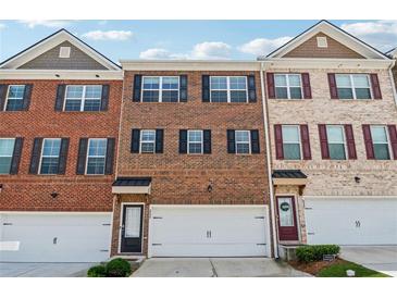 Charming townhomes with brick facades, attached garages, and professionally maintained landscaping at 2237 Foley Park St, Snellville, GA 30078