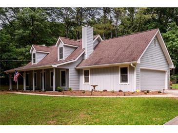 Charming gray home with a two-car garage, dormer windows, and well-maintained lawn at 60 Valley Rd, Covington, GA 30016