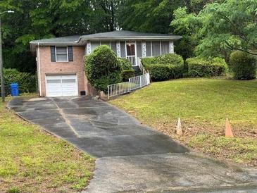 Charming single-Gathering home featuring a one car garage, brick facade, and a well-manicured lawn at 1829 Detroit Ave, Atlanta, GA 30314