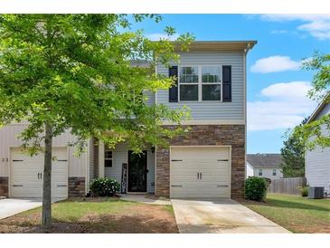 Charming two-story home with stone accents, a single-car garage, and a neatly maintained front yard at 635 Oakside Pl, Acworth, GA 30102