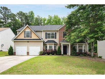 Charming two-story home with a well-manicured lawn, two-car garage, and tasteful landscaping at 6378 Grey Fox Way, Riverdale, GA 30296