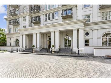 Elegant building entrance with stately columns and decorative landscaping for an inviting arrival at 195 14Th Ne St # 1706, Atlanta, GA 30309