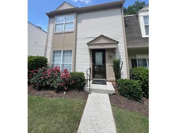 Charming two-story condo with a well-maintained lawn and lovely flower bushes, creating a welcoming curb appeal at 3474 Washington Way, Atlanta, GA 30340