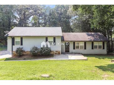 Charming single-story home with light siding, black shutters, and a well-maintained front yard with mature trees at 5243 Valleyview Dr, Acworth, GA 30102