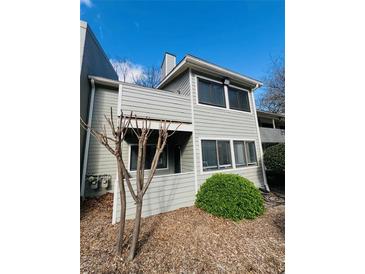 Charming two-story condo featuring tidy landscaping and a private covered deck at 3432 Ivys Walk, Atlanta, GA 30340