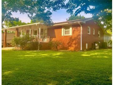 Charming brick home with a covered porch and a spacious front yard perfect for outdoor activities at 3629 Centerview Dr, Marietta, GA 30066