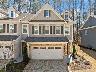 Beautiful two-story townhome with a two-car garage and charming architectural details at 495 Duval Dr, Alpharetta, GA 30009