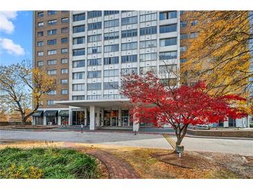 Residential high-rise building with well-maintained landscaping and a circle drive entrance at 215 Piedmont Ne Ave # 303, Atlanta, GA 30308