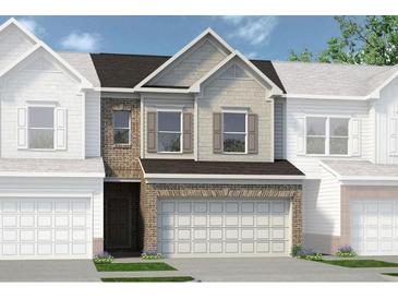 Charming townhome showcasing a two-car garage and attractive mixed-material facade at 102 Jacobs Farm Ln # 40, Lawrenceville, GA 30045