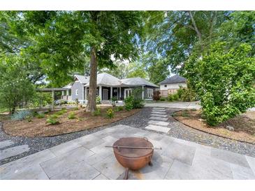 An exterior view of a well-maintained backyard and patio, with a view of the house at 1228 Hosea L Williams Ne Dr, Atlanta, GA 30317