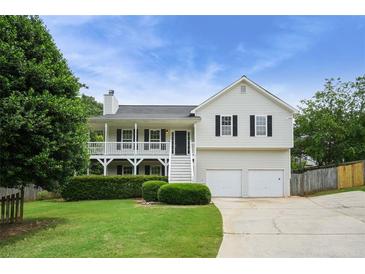 Charming two-story home with a welcoming front porch, tidy landscaping, and a two-car garage at 259 Pine Valley Dr, Powder Springs, GA 30127