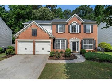 Charming two-story brick home with a well-manicured lawn and a two-car garage at 4321 Sugar Maple Chase Nw, Acworth, GA 30101