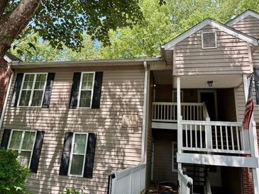 Two-story townhome featuring black shuttered windows and a covered entrance way at 386 Teal Ct, Roswell, GA 30076
