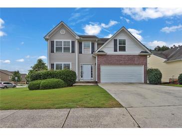 Charming two-story home with a well-manicured lawn and a two-car garage, perfect for Gathering living at 771 Franklin Mill Trce, Loganville, GA 30052