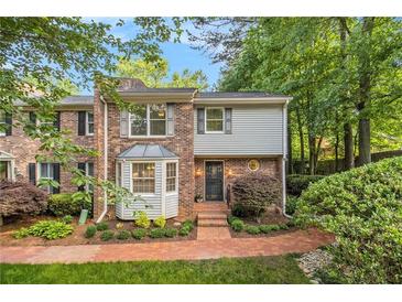 Charming two-story townhome with brick facade, bay window, and landscaped front yard at 1505 September Chase, Decatur, GA 30033