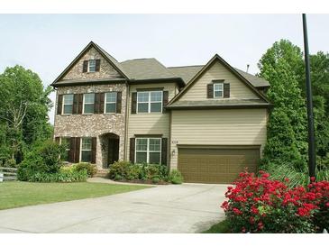 Charming two-story home boasts brick and siding exterior, well-manicured lawn, and a two-car garage at 4020 Alligator Pt, Cumming, GA 30028