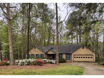 Charming single-story home featuring a well-maintained yard and a cozy, inviting entrance at 2513 Rockwood Way, Stone Mountain, GA 30087