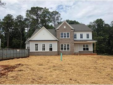 New home features brick and siding, black trimmed windows, and a covered porch at 3435 Dr Bramblett Rd, Cumming, GA 30028