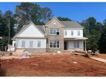 New home under construction shows brick exterior with double-hung windows and contrasting white trim at 3435 Dr Bramblett Rd, Cumming, GA 30028