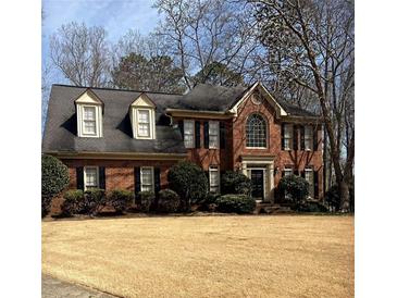 Charming brick home featuring a well-manicured lawn and traditional architectural design at 3580 Treeline Ne Pass, Roswell, GA 30075