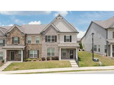 Charming two-story townhome with a well-maintained lawn and inviting front entrance at 2692 Pearl Ridge Trce, Buford, GA 30519
