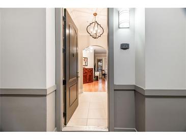Welcoming entryway with tile flooring, chandelier lighting, and a view into the living area at 3621 Vinings Slope Se # 1231, Atlanta, GA 30339
