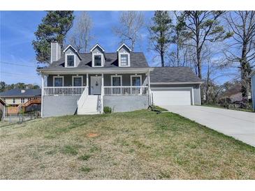 Charming two-story home with a front porch and attached two-car garage at 1001 Pine Ridge Dr, Stone Mountain, GA 30087