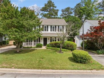 Charming two-story home featuring a well-manicured lawn, mature trees and classic black shutters at 3405 Haverhill Rowe, Lawrenceville, GA 30044